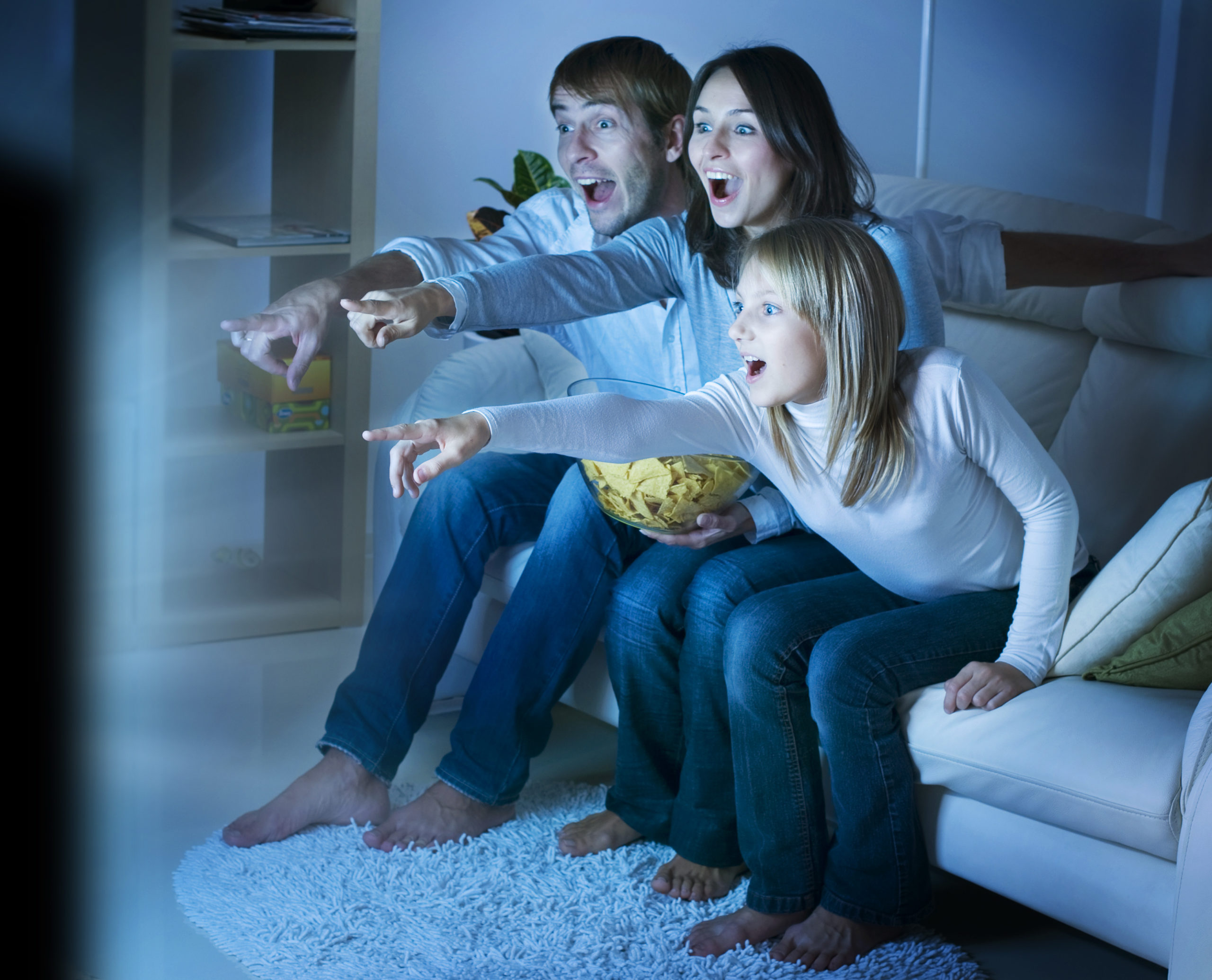 family watching exciting movie in new home theater