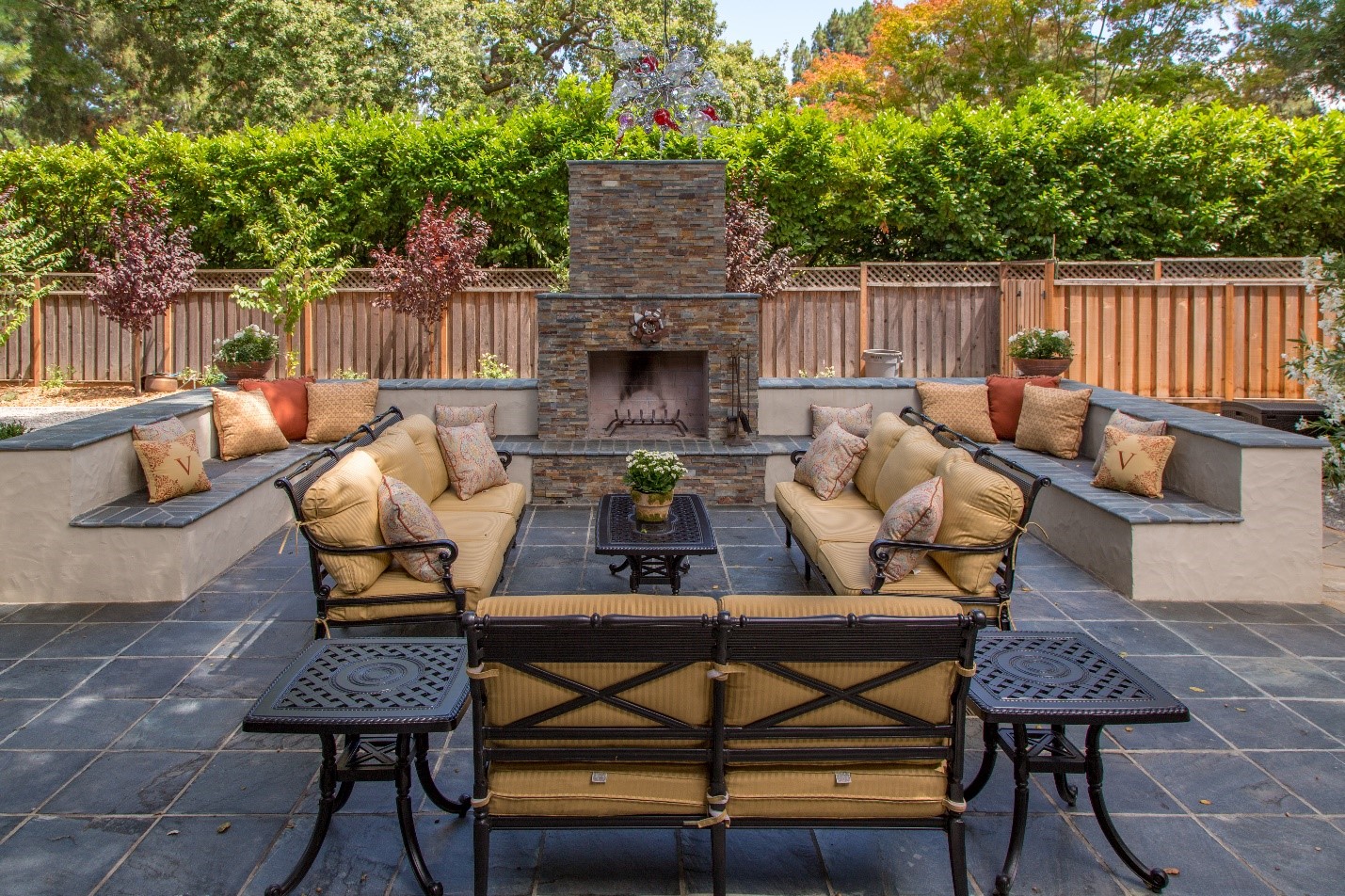 Outdoor living room space with chairs and fireplace