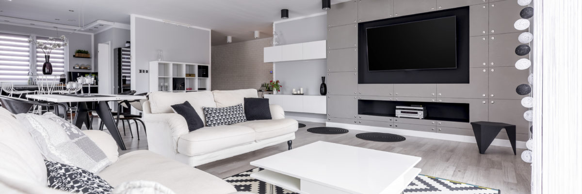An open-plan living room with a huge tv