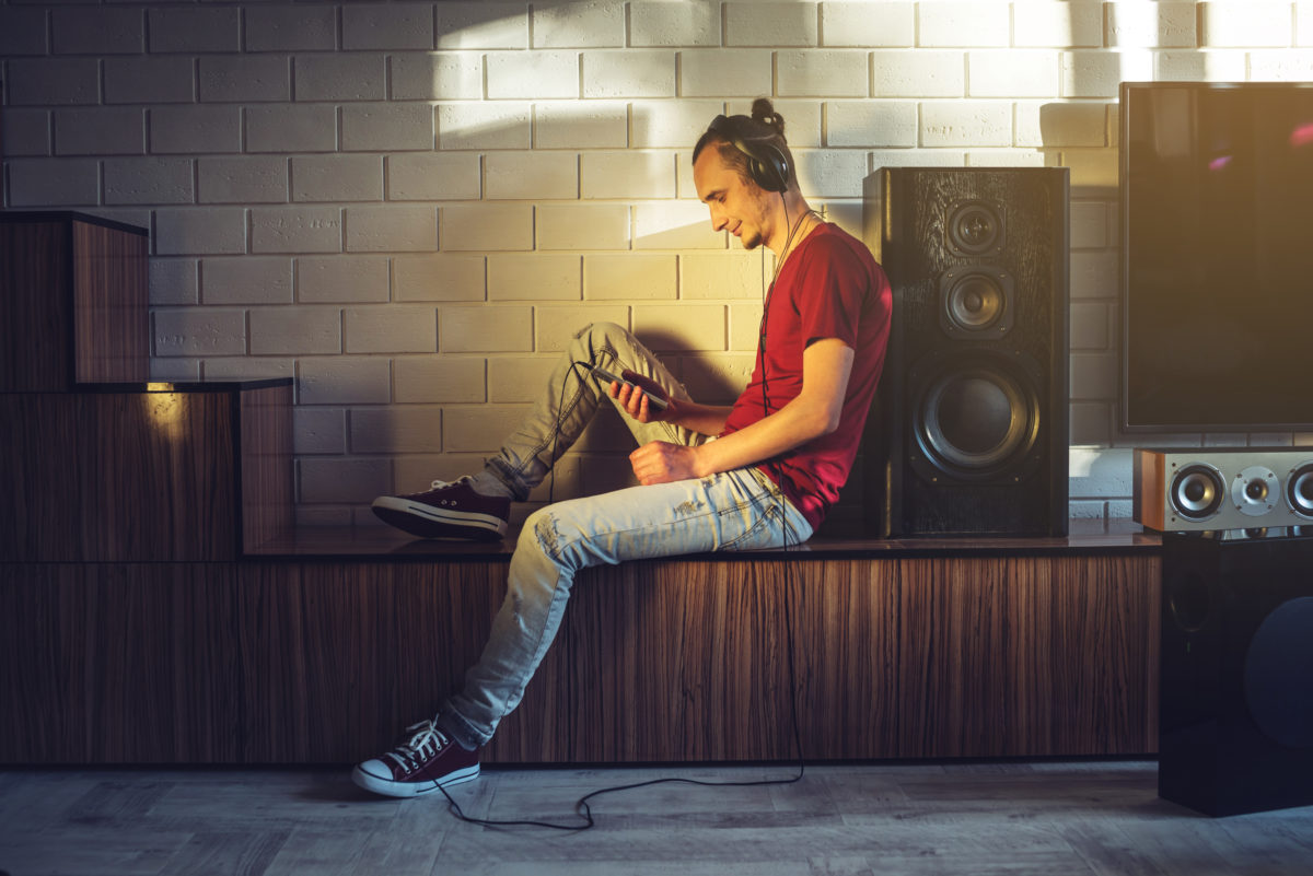 Young man listens to music at home